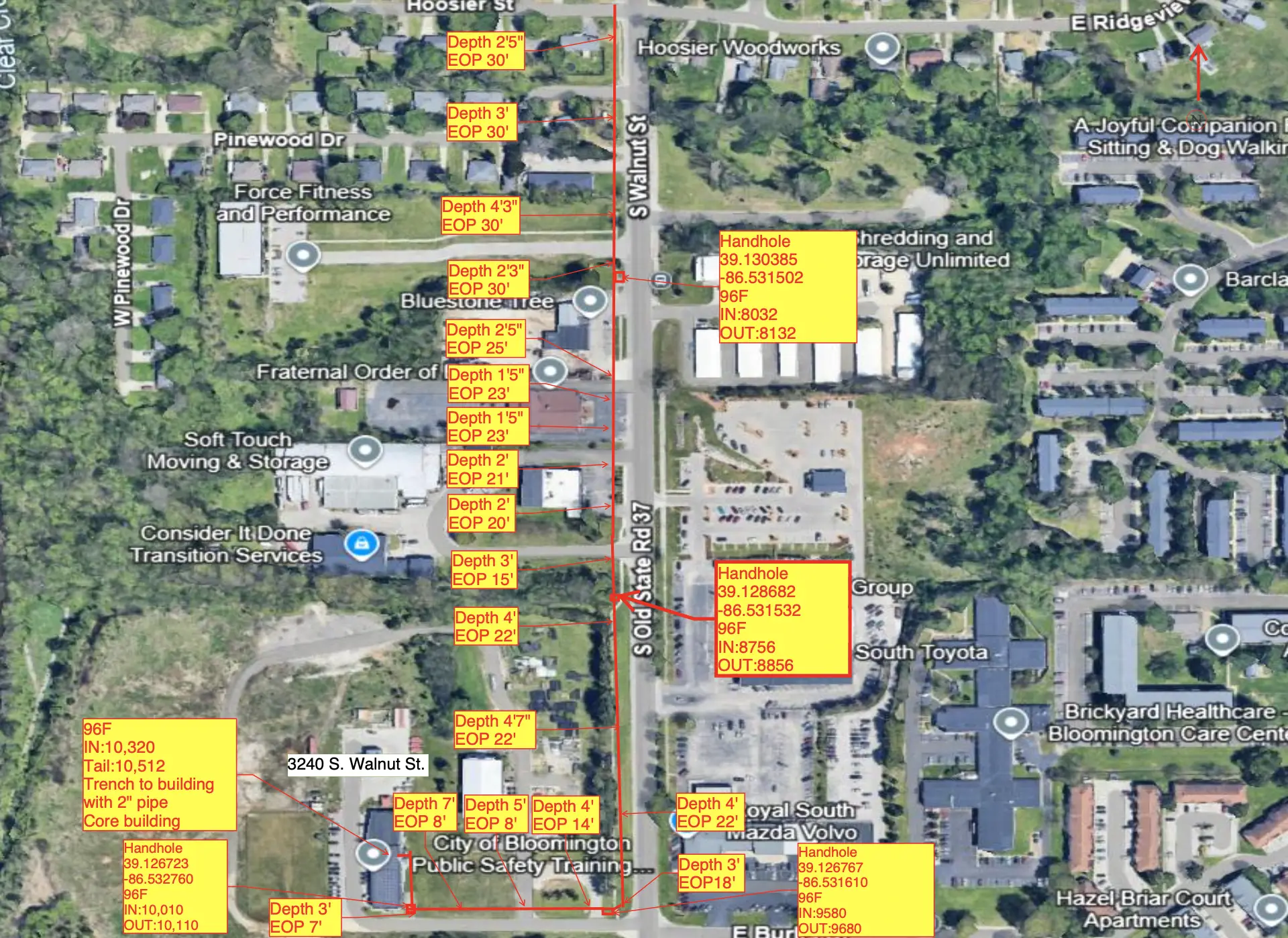 Aerial map of a street with properties, yellow labels, and red lines marking a utility route.